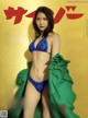 A woman in a blue bikini on a magazine cover.