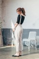 a woman standing in front of a white chair