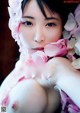 A woman with a flower crown on her head is posing for the camera.